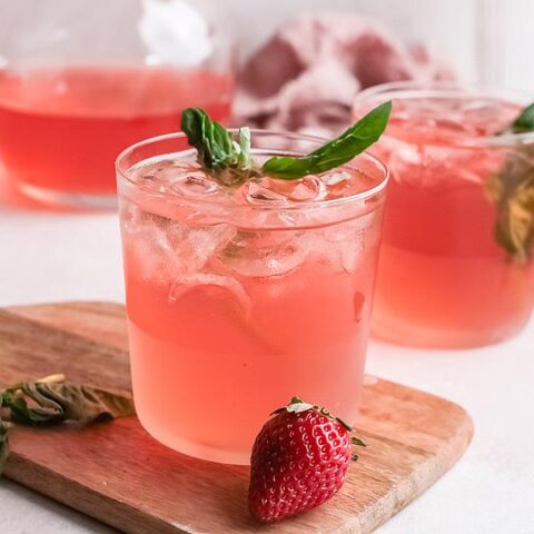 Pink strawberry gin cocktails garnished with fresh mint.