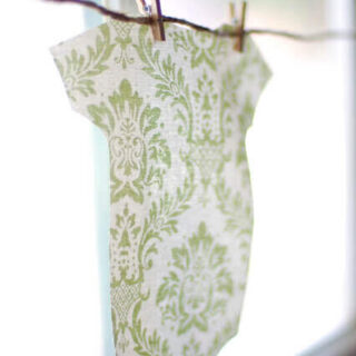 A bunting made with scrap fabric cut to look like a baby onesie.