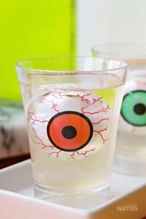 Close up of a jello shot with a floating gummy eyeball inside.