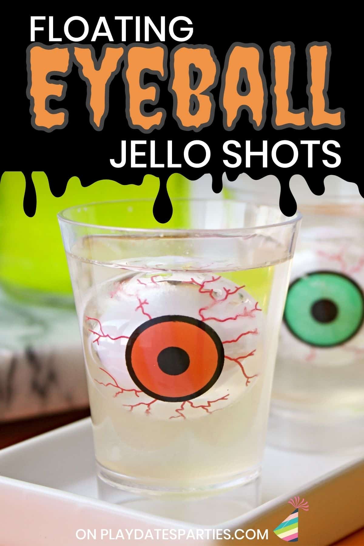 A floating eyeball jello shot for Halloween on a white tray.