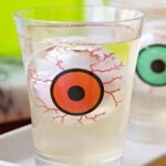 Close up of a jello shot with a floating eyeball inside.