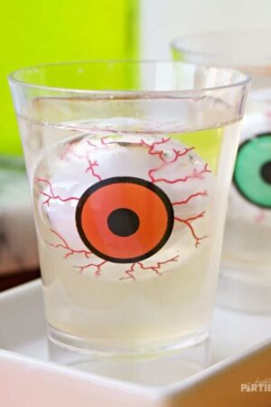 Close up of a jello shot with a floating eyeball inside.