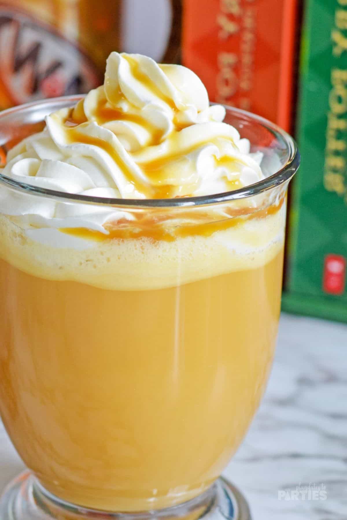 Easy butterbeer recipe in a mug with whipped cream.