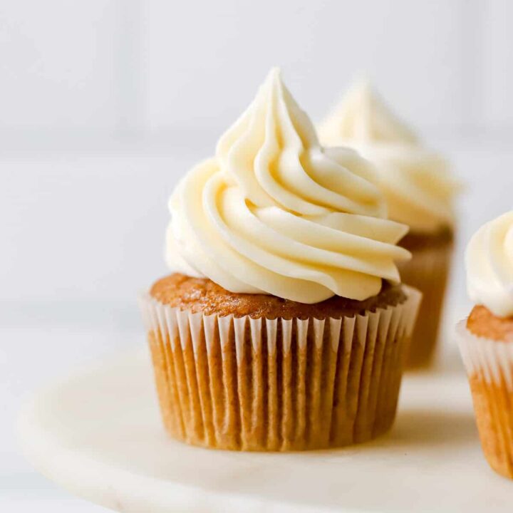 Pumpkin spice cupcakes with vanilla frosting.