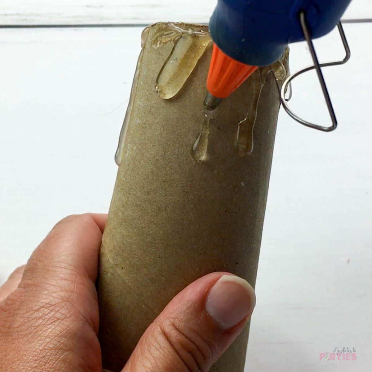 Adding fake wax drips with hot glue.