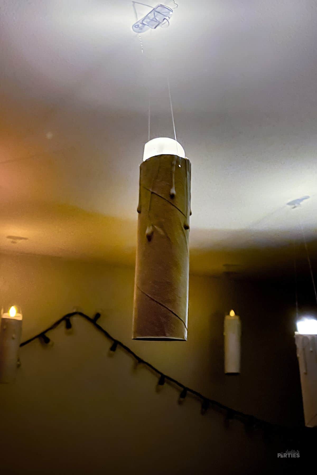 In a dark room DIY floating candles light up the ceiling.