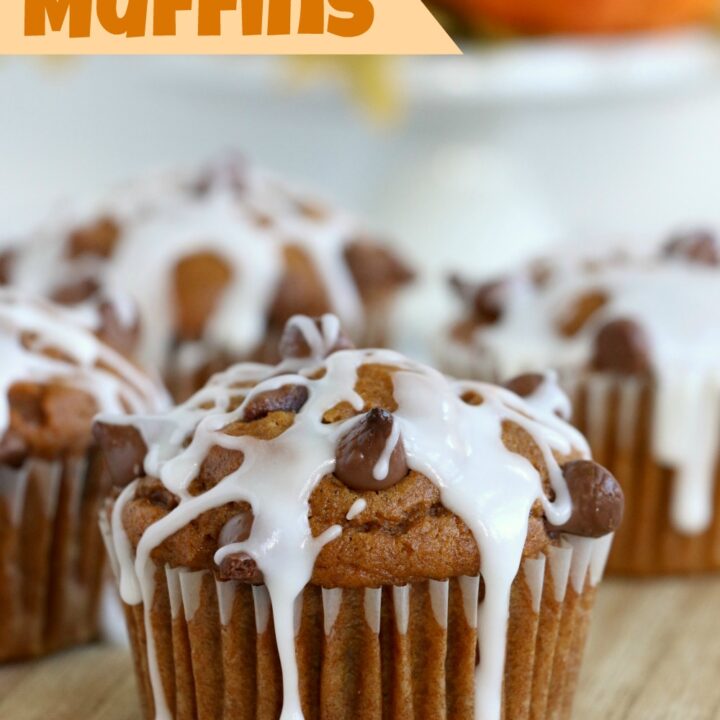 Chocolate chip pumpkin muffins on a cutting board.