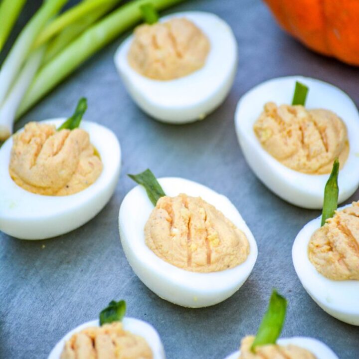 Deviled eggs filled and decorated to look like little pumpkins.