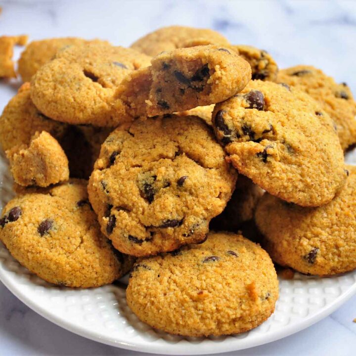 A plate of pumpkin cookies on a white plate.