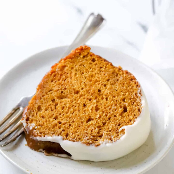 A slice of pumpkin bundt cake on a white plate.