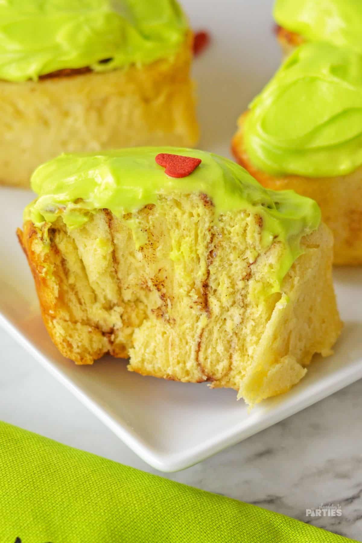 Inside of cinnamon rolls with green frosting.