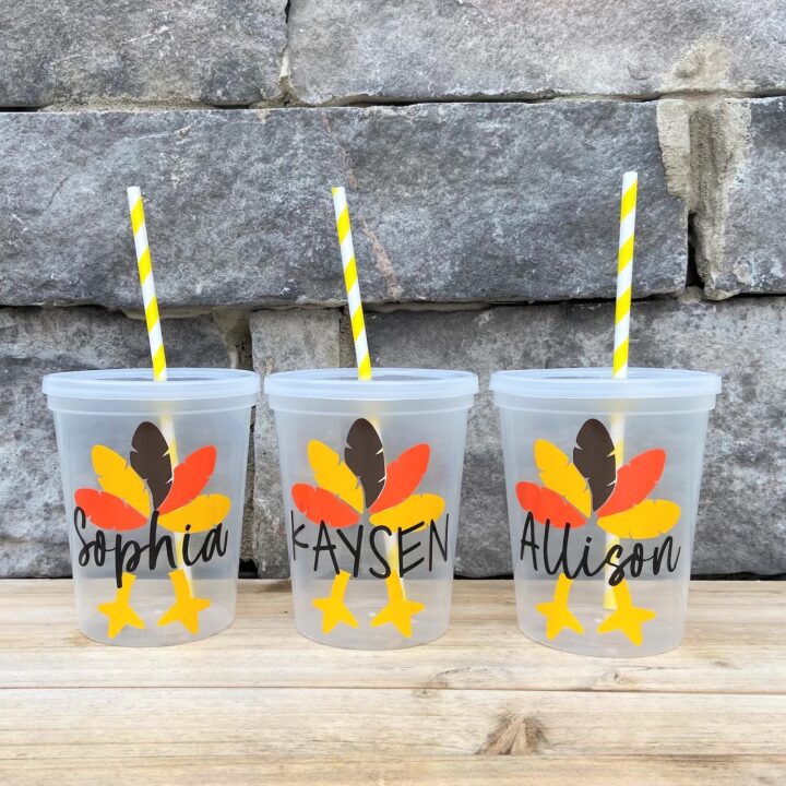 Clear plastic cups decorated with turkey decals and custom names.