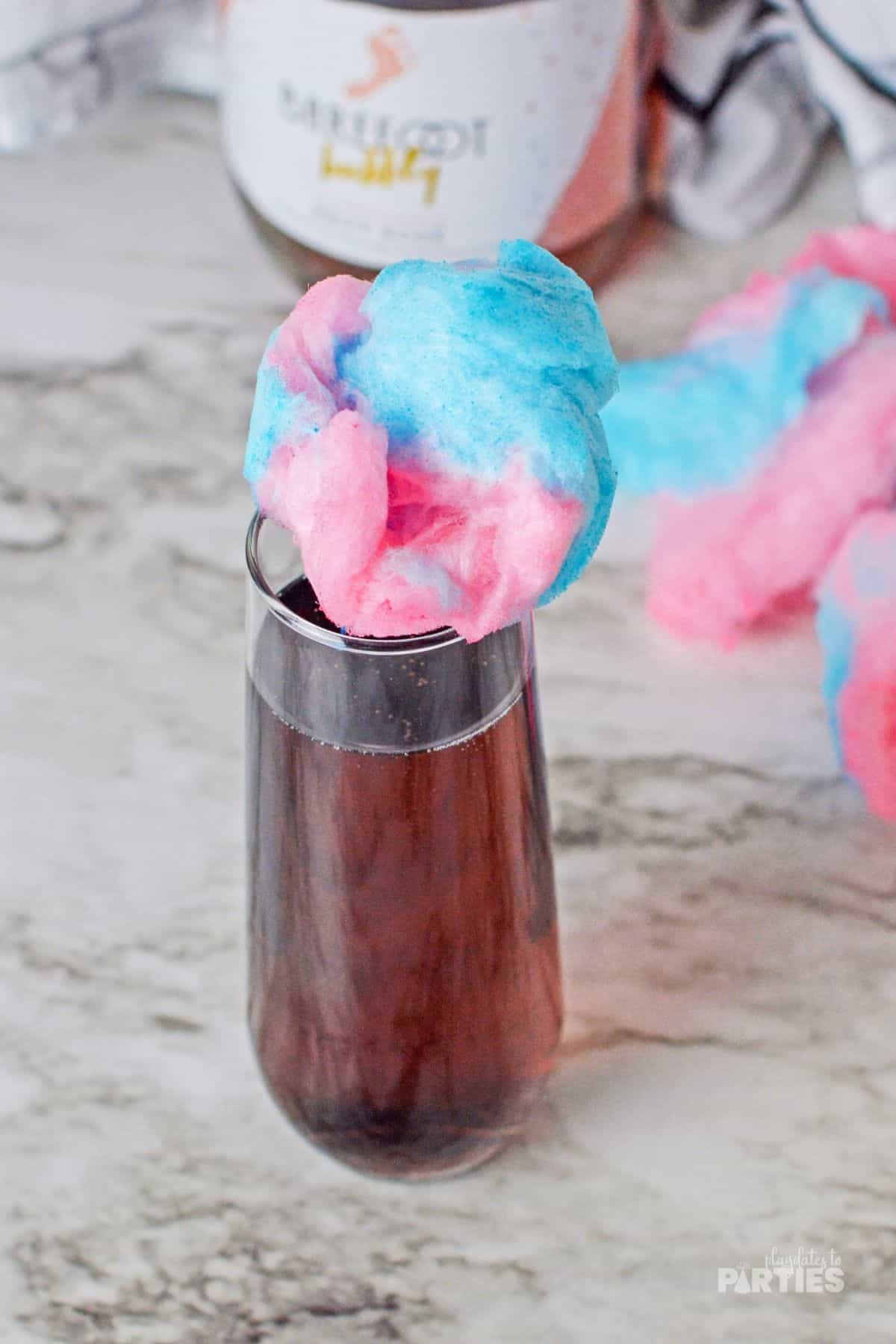 A champagne flute topped with cotton candy.