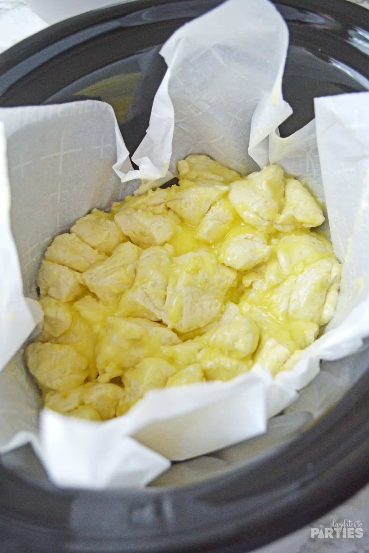 Buttery biscuit pieces in a crock pot.