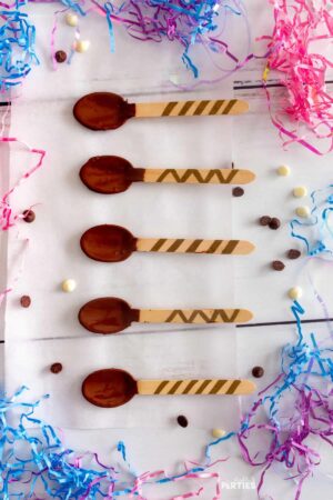 Wood spoons dipped in chocolate with decorated handles.