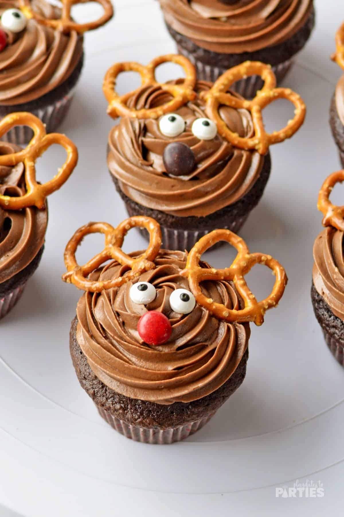 Reindeer cupcake with pretzel antlers.