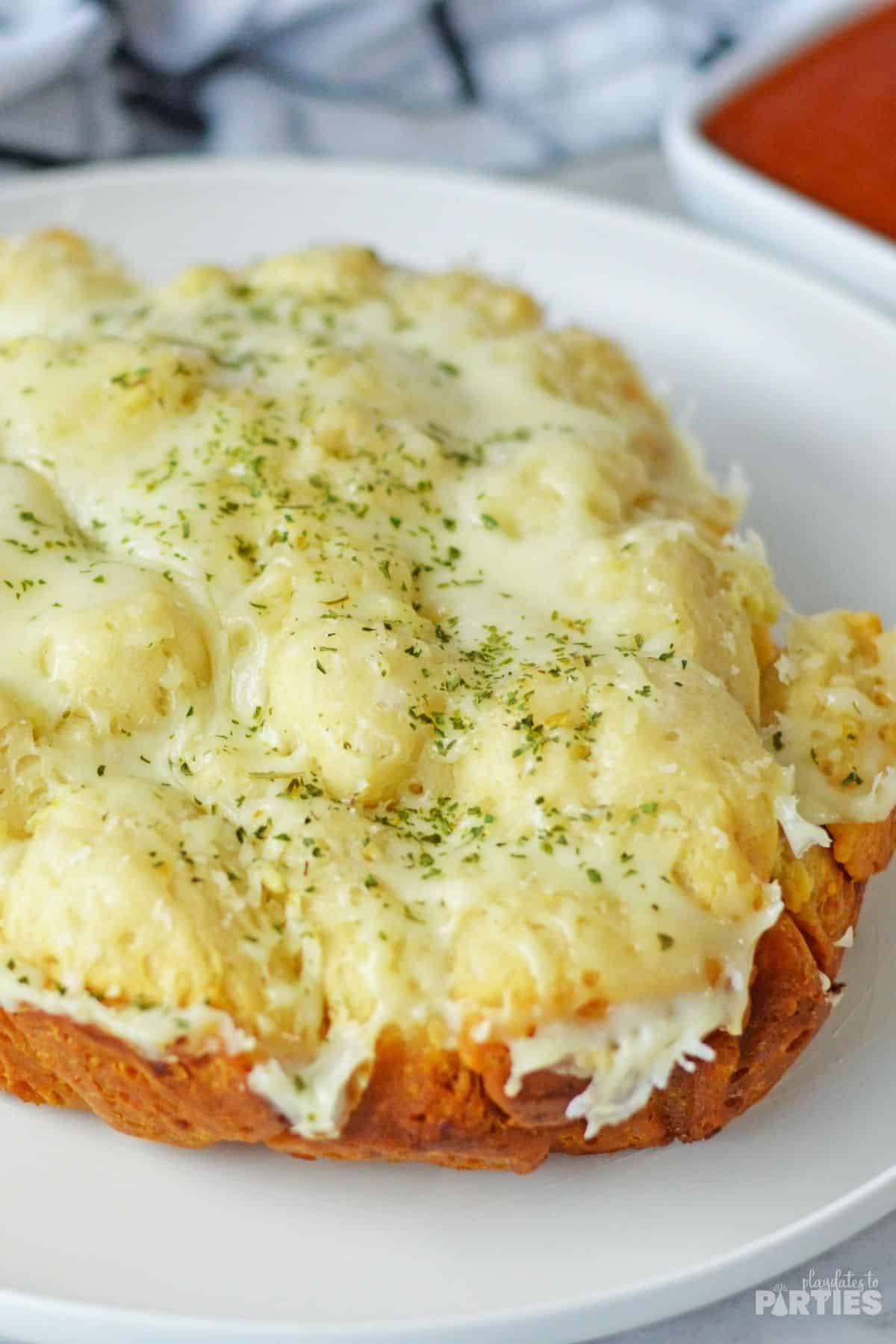 Side view of a cheesy appetizer bread.