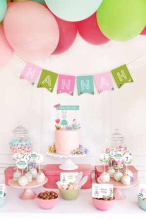 A dessert table for a bunny themed party with pastel pinks, blues, and greens.