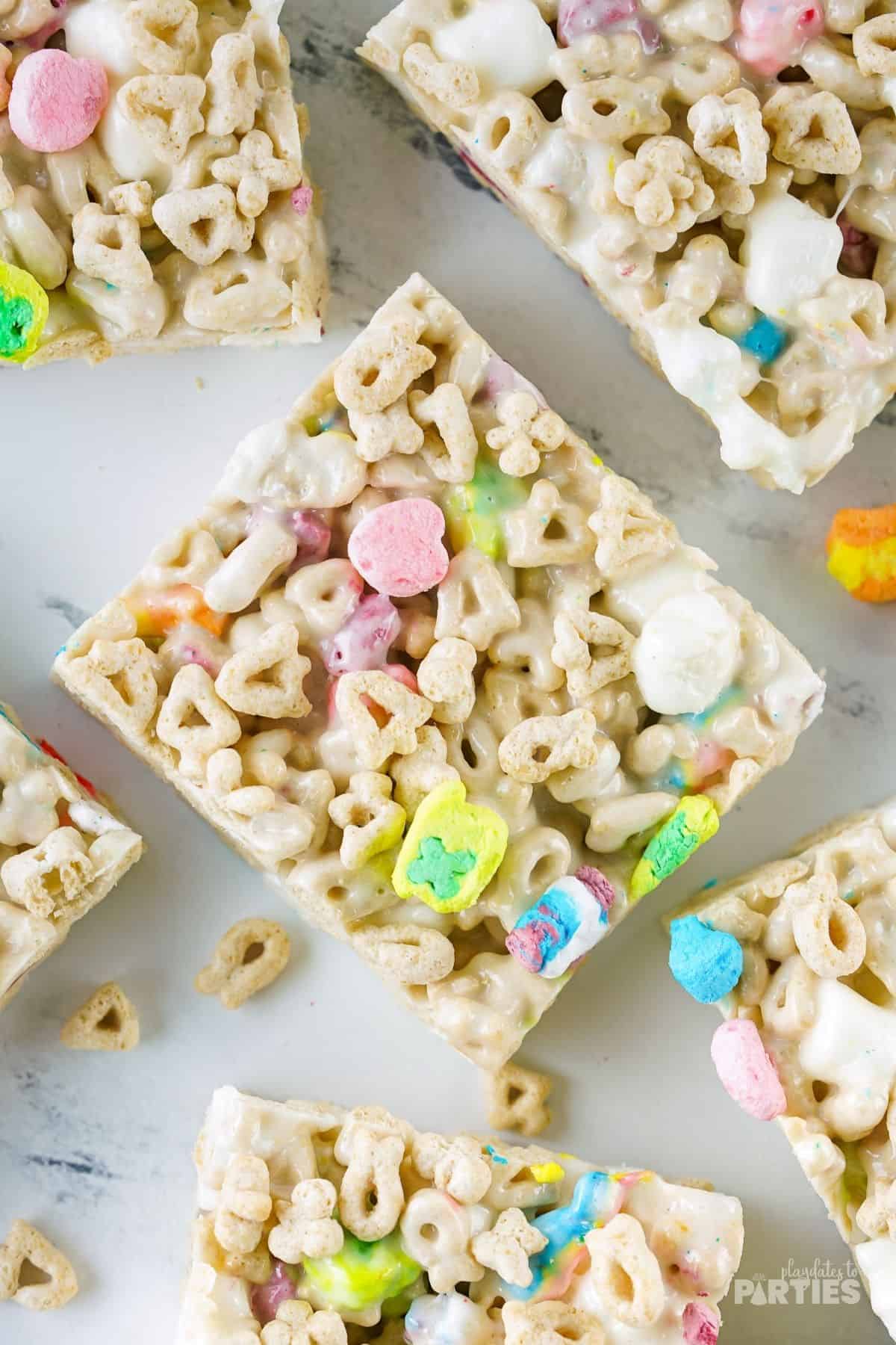 Lucky Charms Marshmallow Treats on a marble surface.
