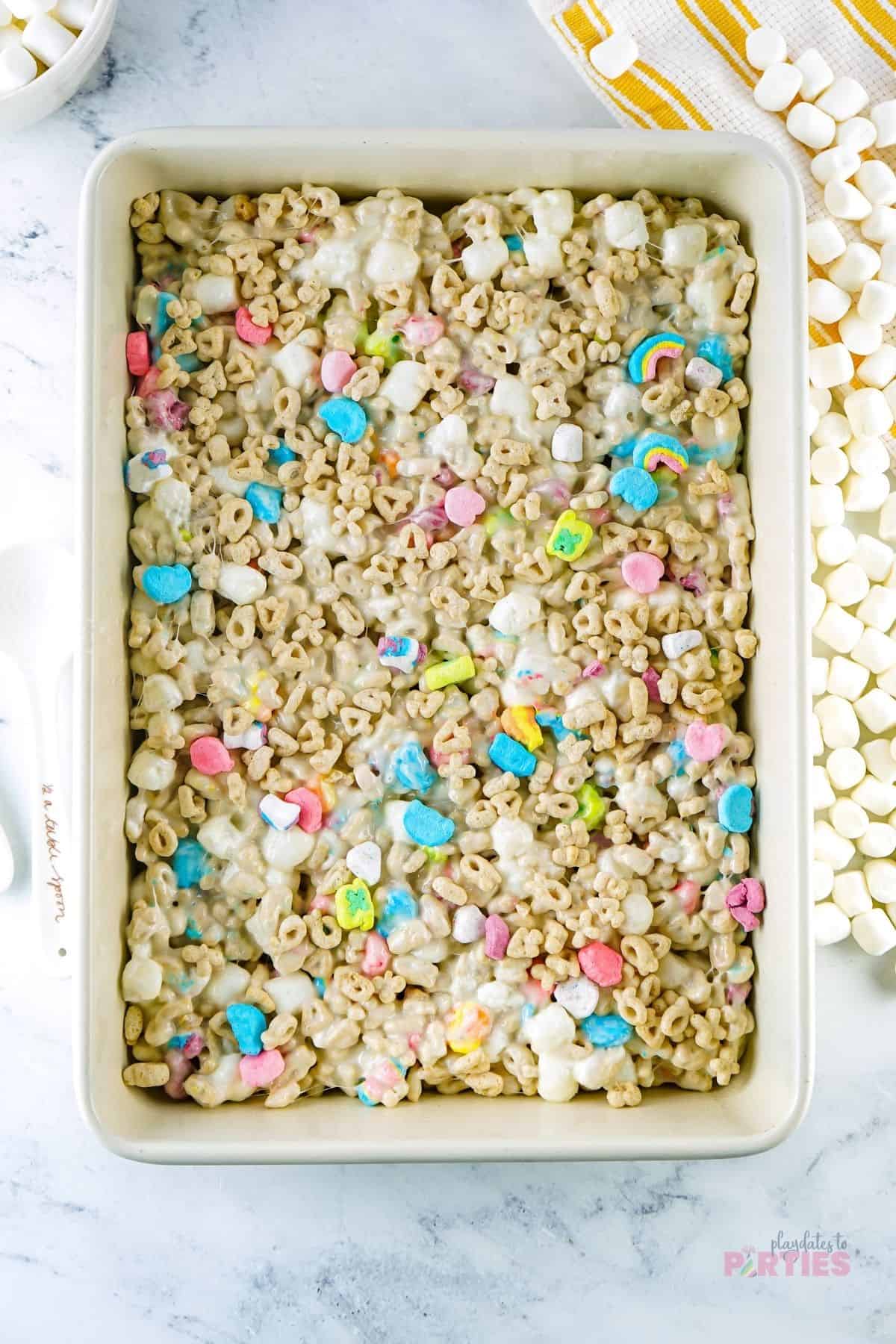 Lucky Charms Rice Krispie treats in a pan.