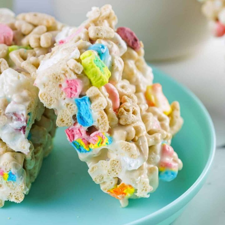 Side view of a colorful cereal marshmallow treat on an aqua plate.