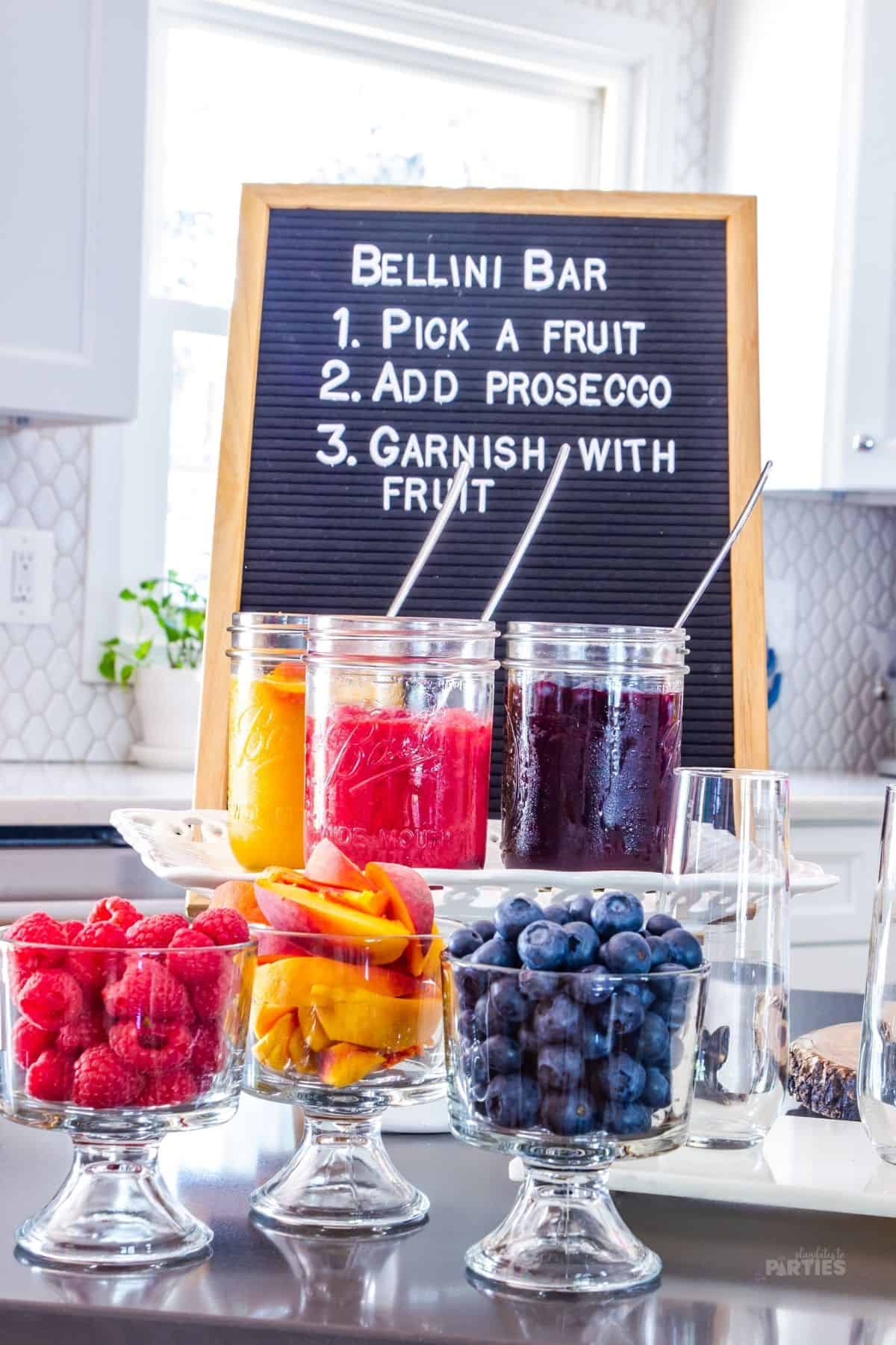 A Bellini bar with a felt letter board and three fruit purees.