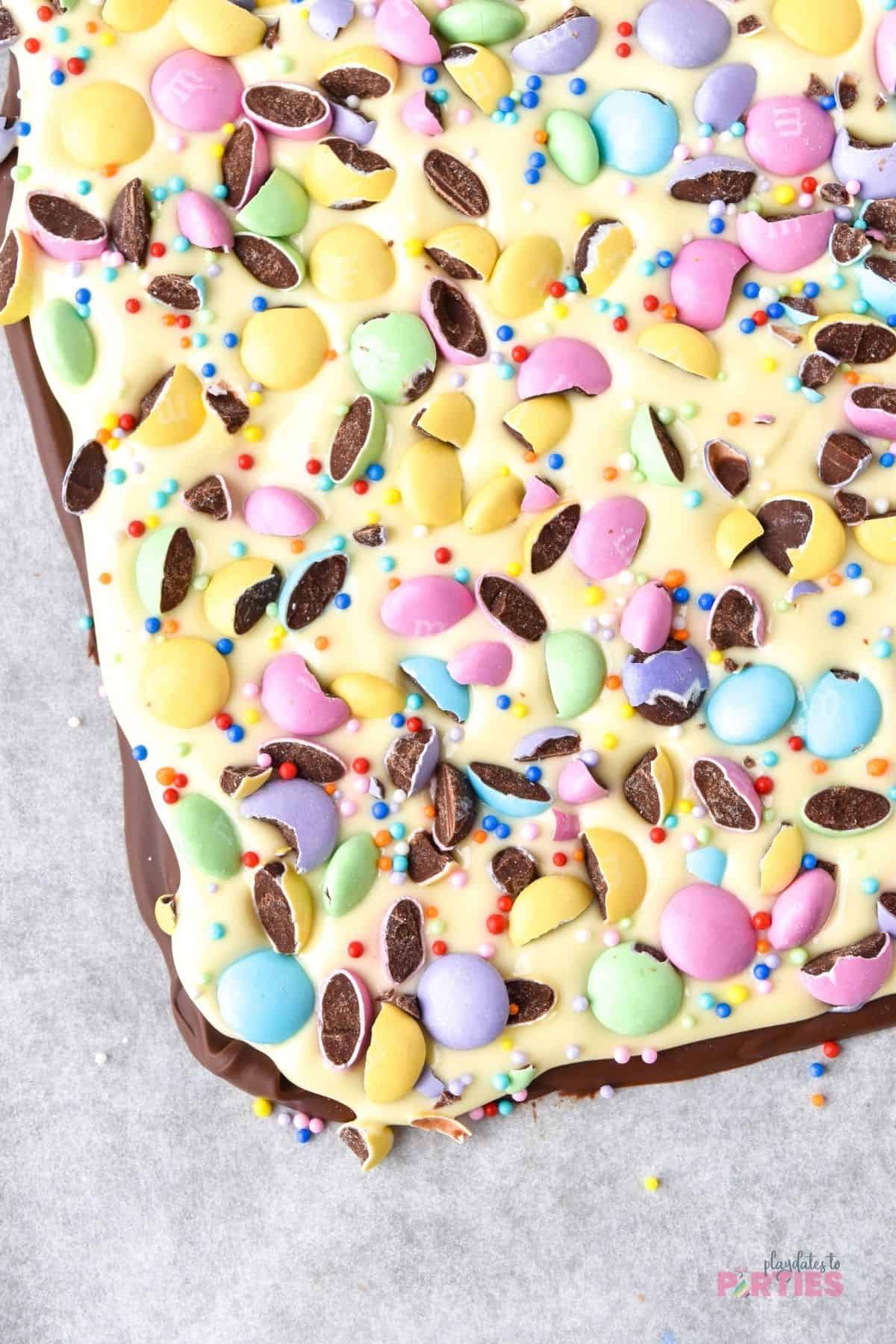 Easter candy with chocolate, pastel M&Ms, and sprinkles.