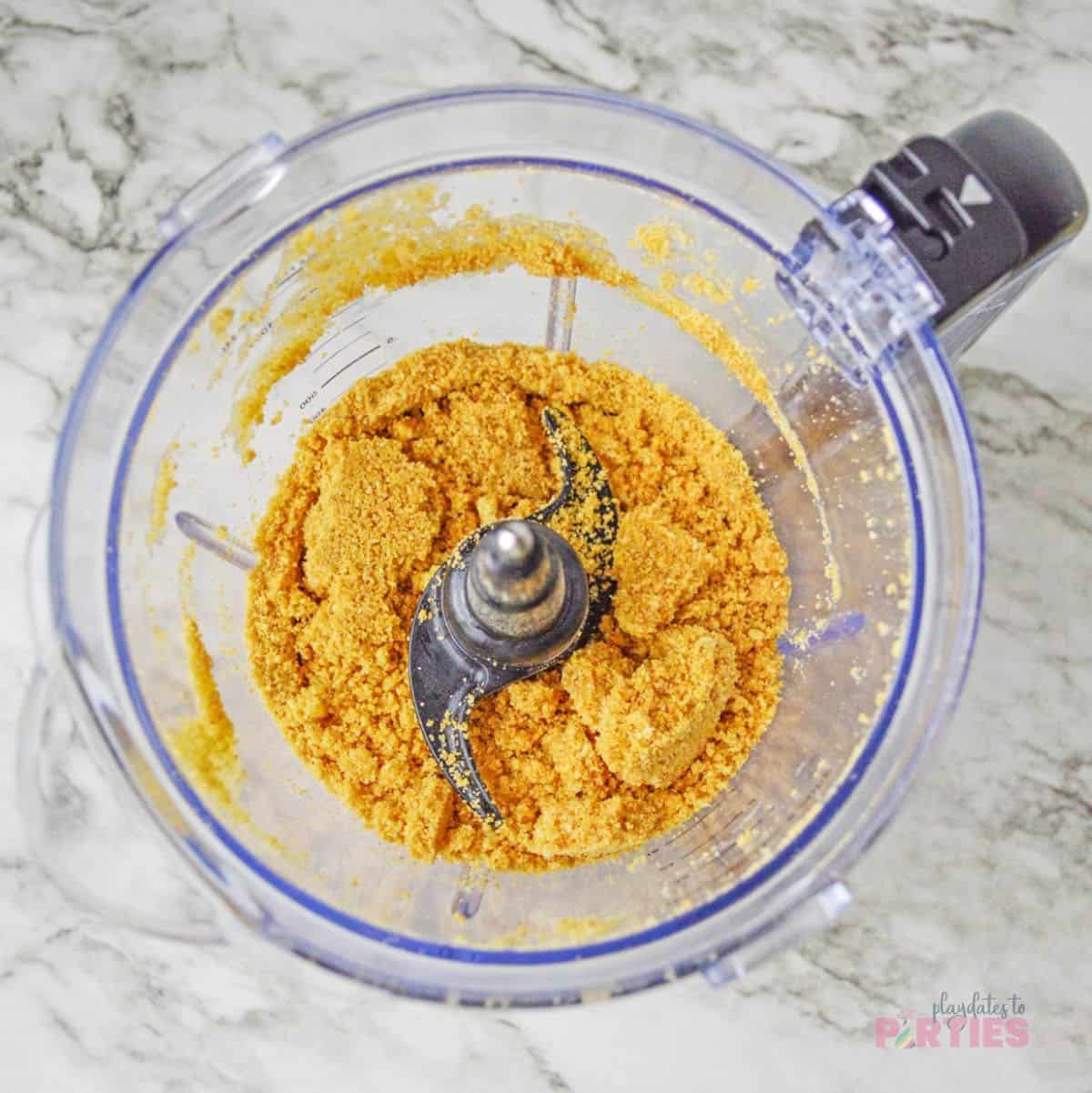 Graham cracker crumbs are made by pulsing them in a food processor until ground.