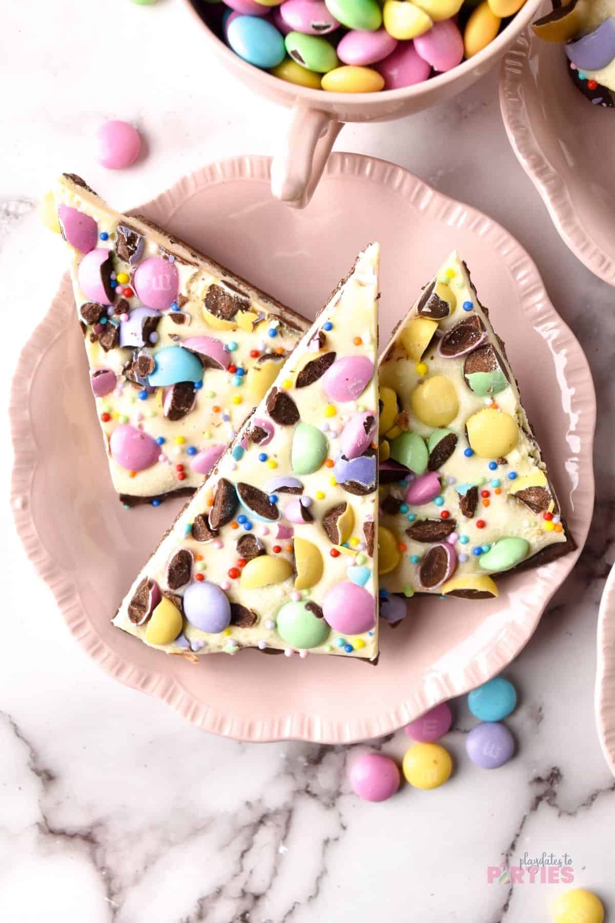 Overhead view of Easter bunny bark on a pink plate.