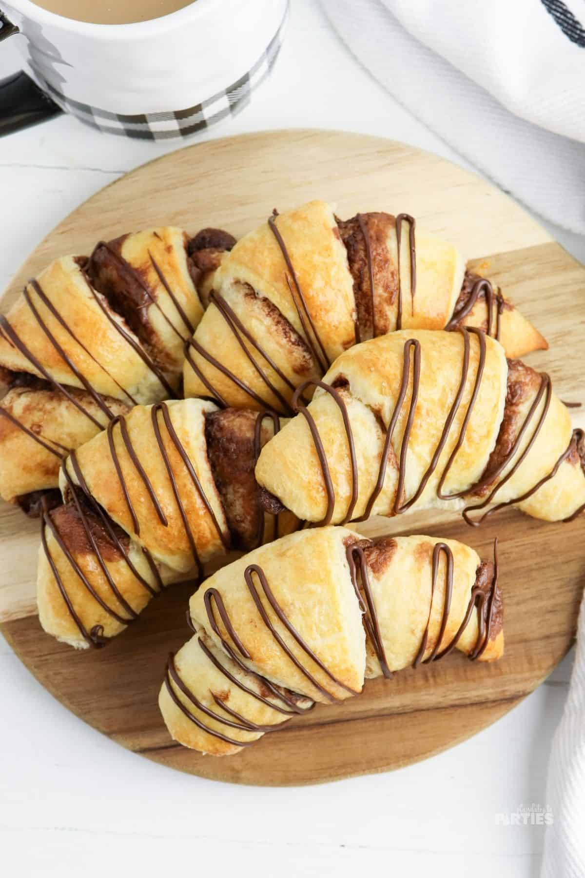 Overhead view of Nutella stuffed crescent rolls on a wood board.