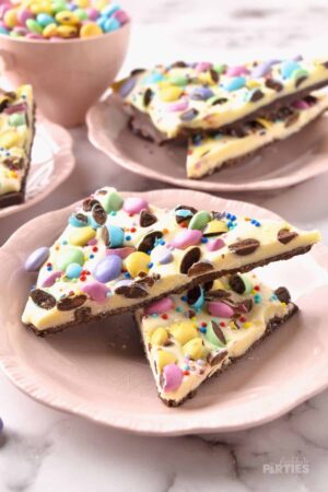 Two slices of Easter bark with M and Ms on a Pink Plate.