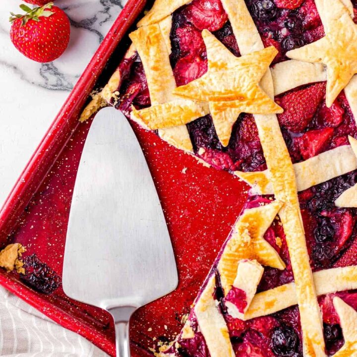 A berry slab pie with a slice cut out.