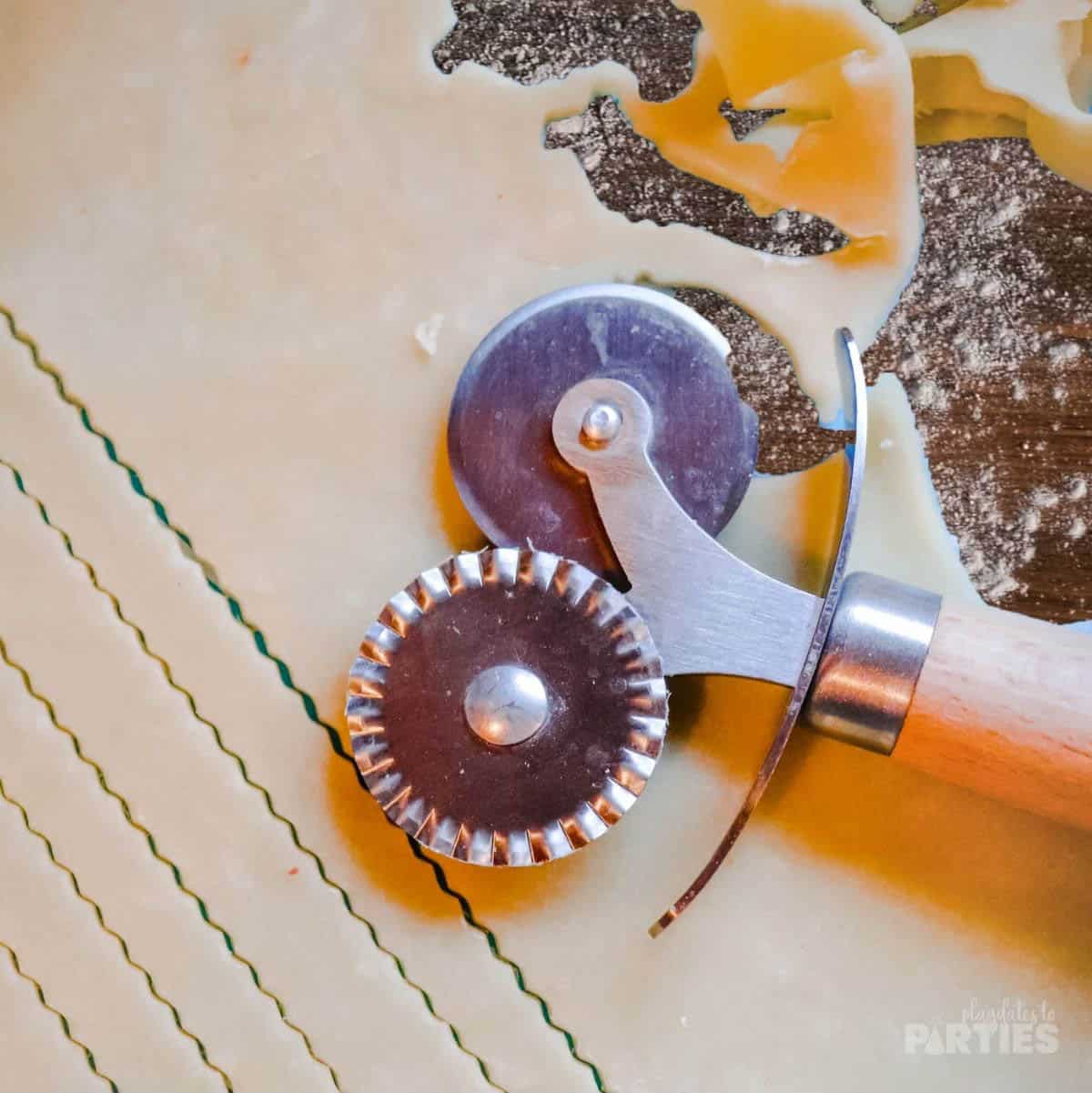 A pastry wheel is used to easily cut pie crust strips.