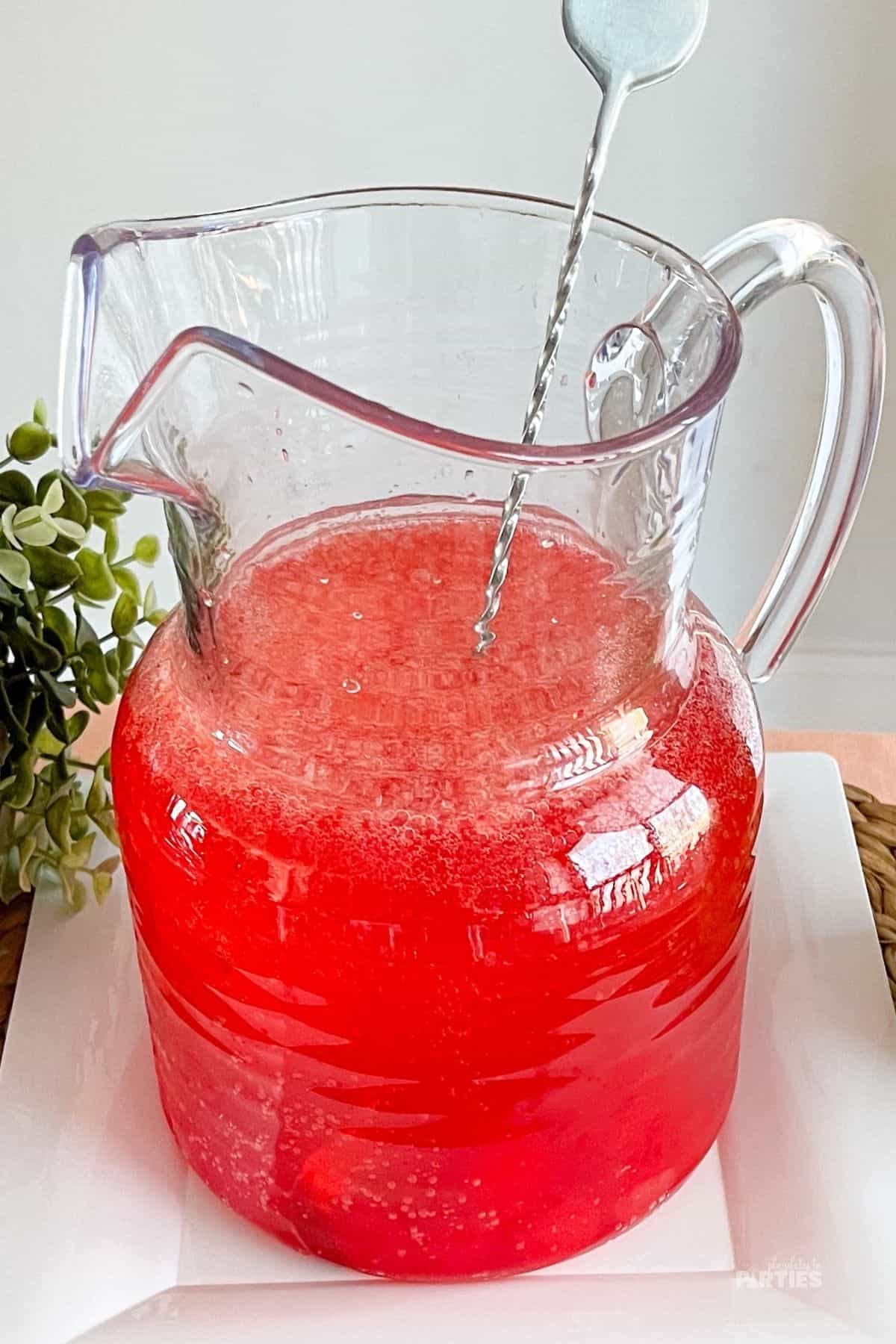 A pitcher with red cherry punch.