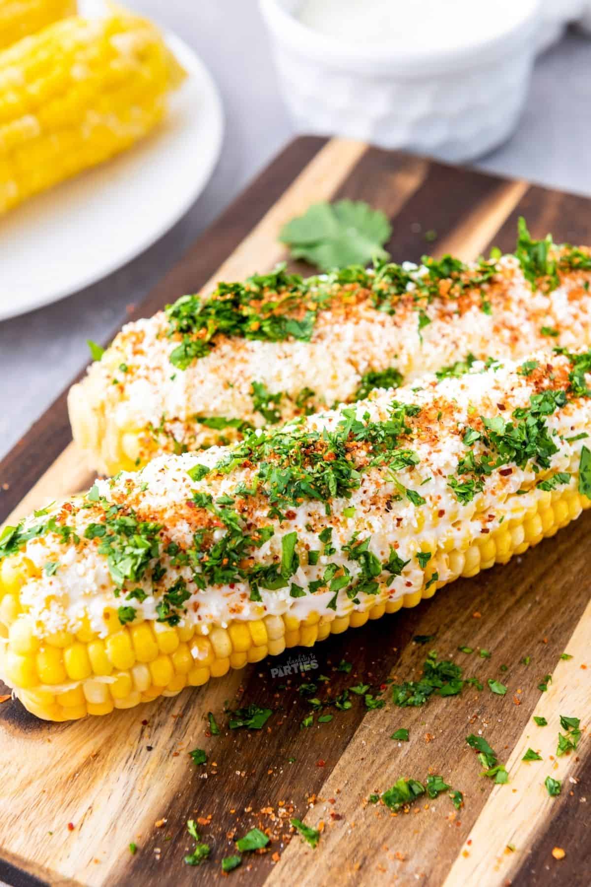 Corn on the cob coated with Mexican crema sauce, cheese, and seasonings.