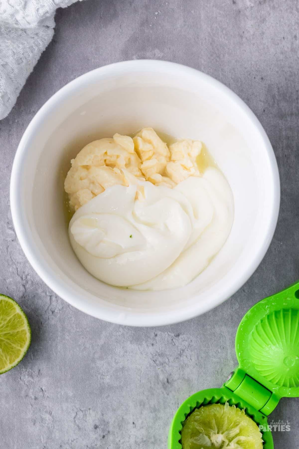 Mixing crema, mayonnaise, lime juice in a small bowl.