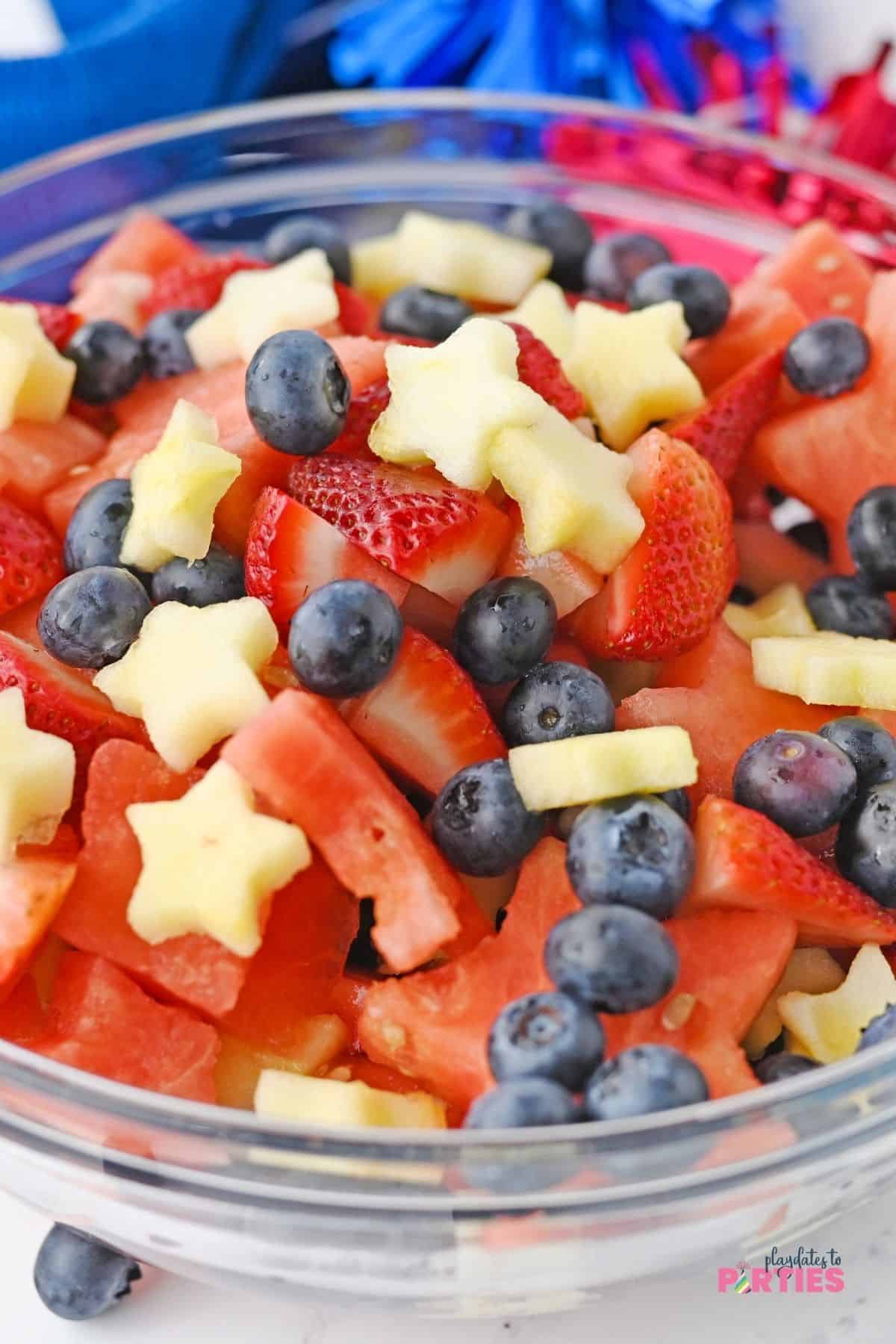 Looking closely at the July 4th fruit salad, the white apple stars pop against the red and blue fruits.