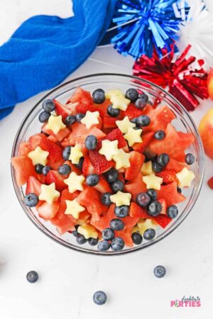Red, white, and blue fruit salad in a glass bowl.