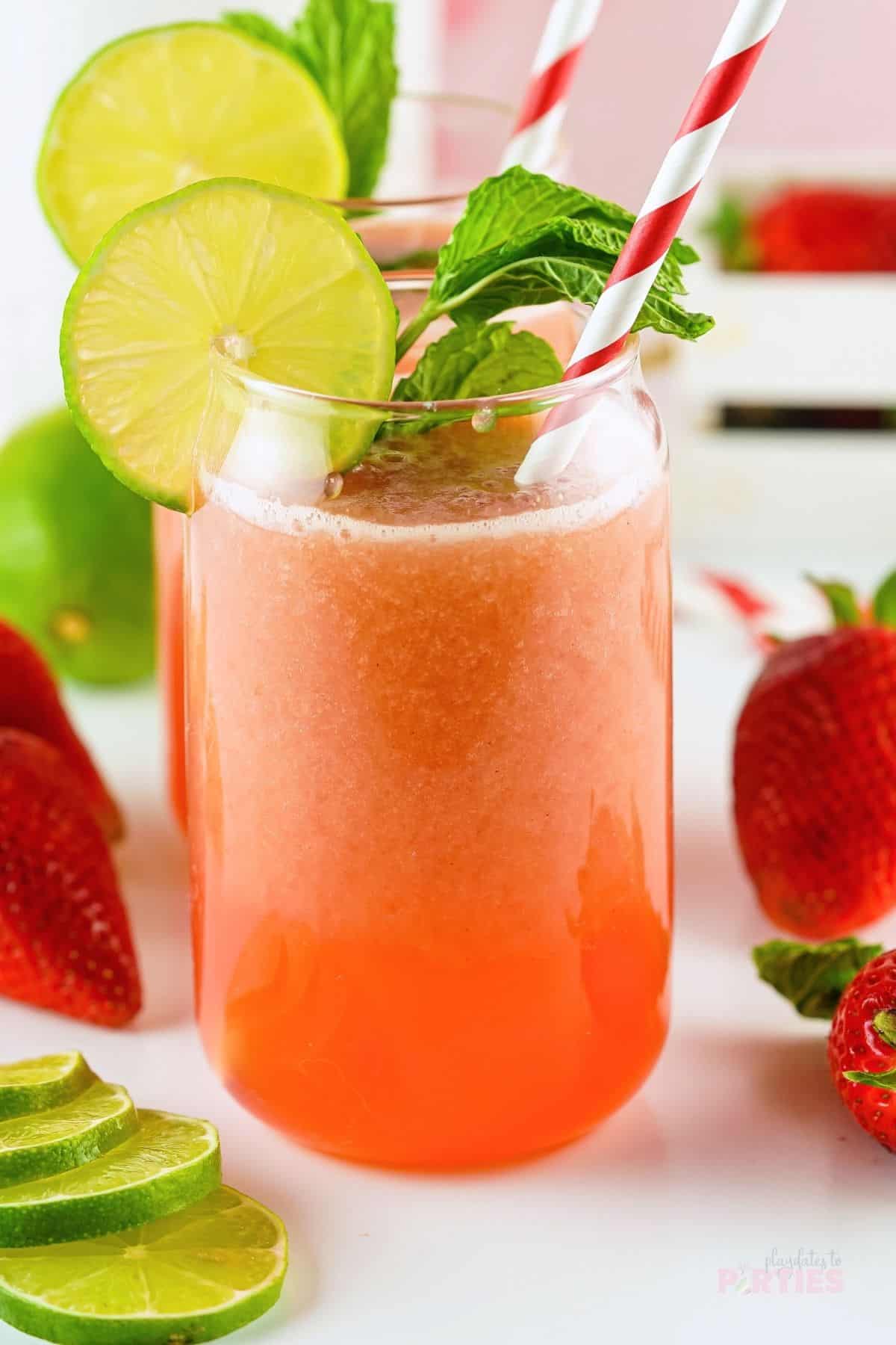 Strawberry agua fresca garnished with mint and lime.