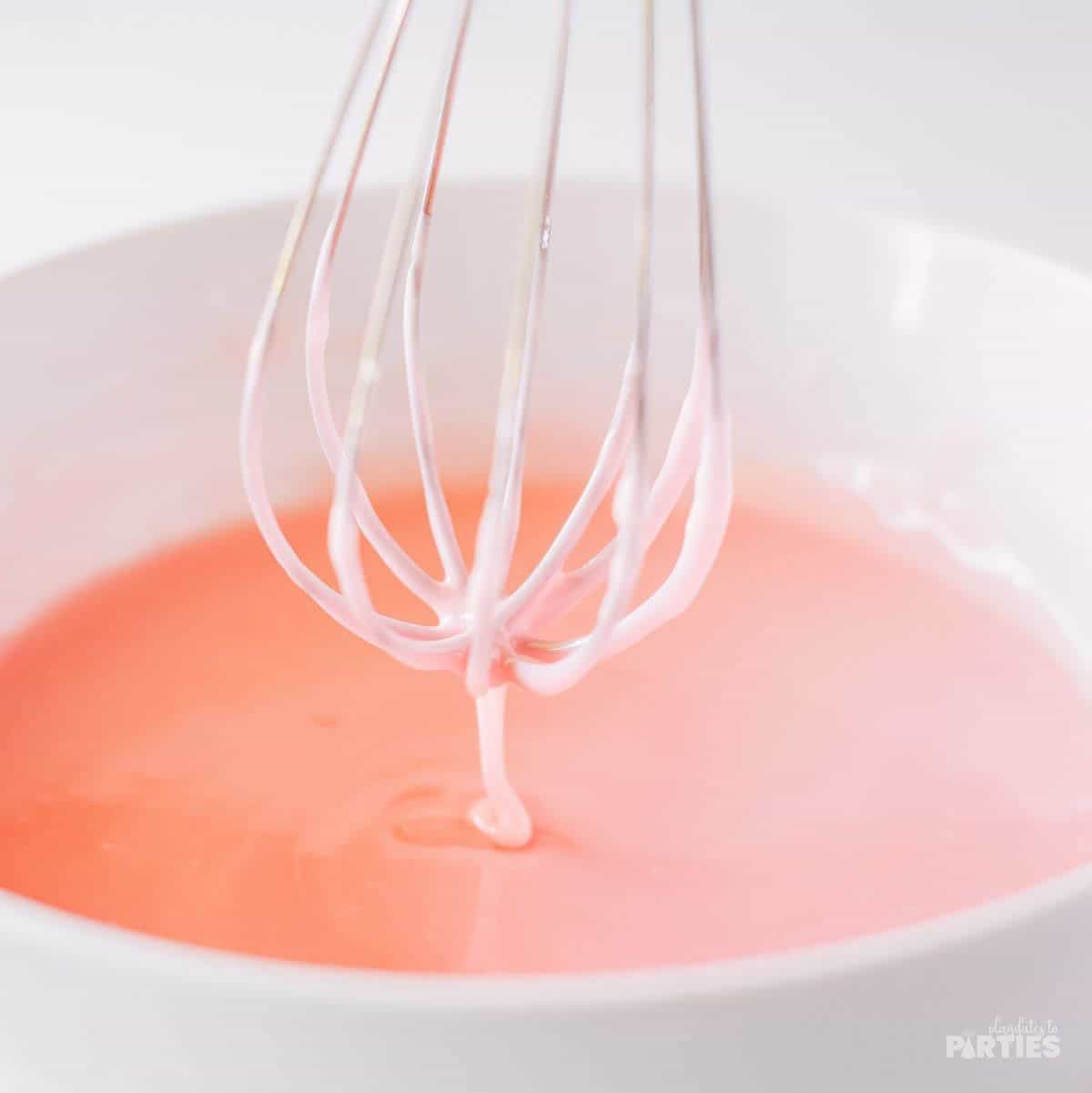 Mixing up the pink strawberry glaze.