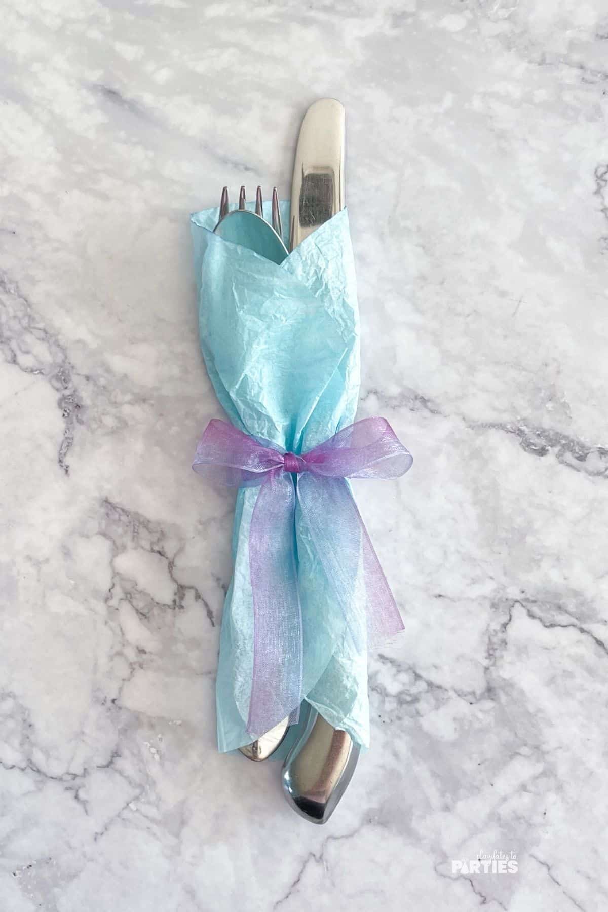 A finished coffee filter utensil wrap with a blue pastel coffee filter.