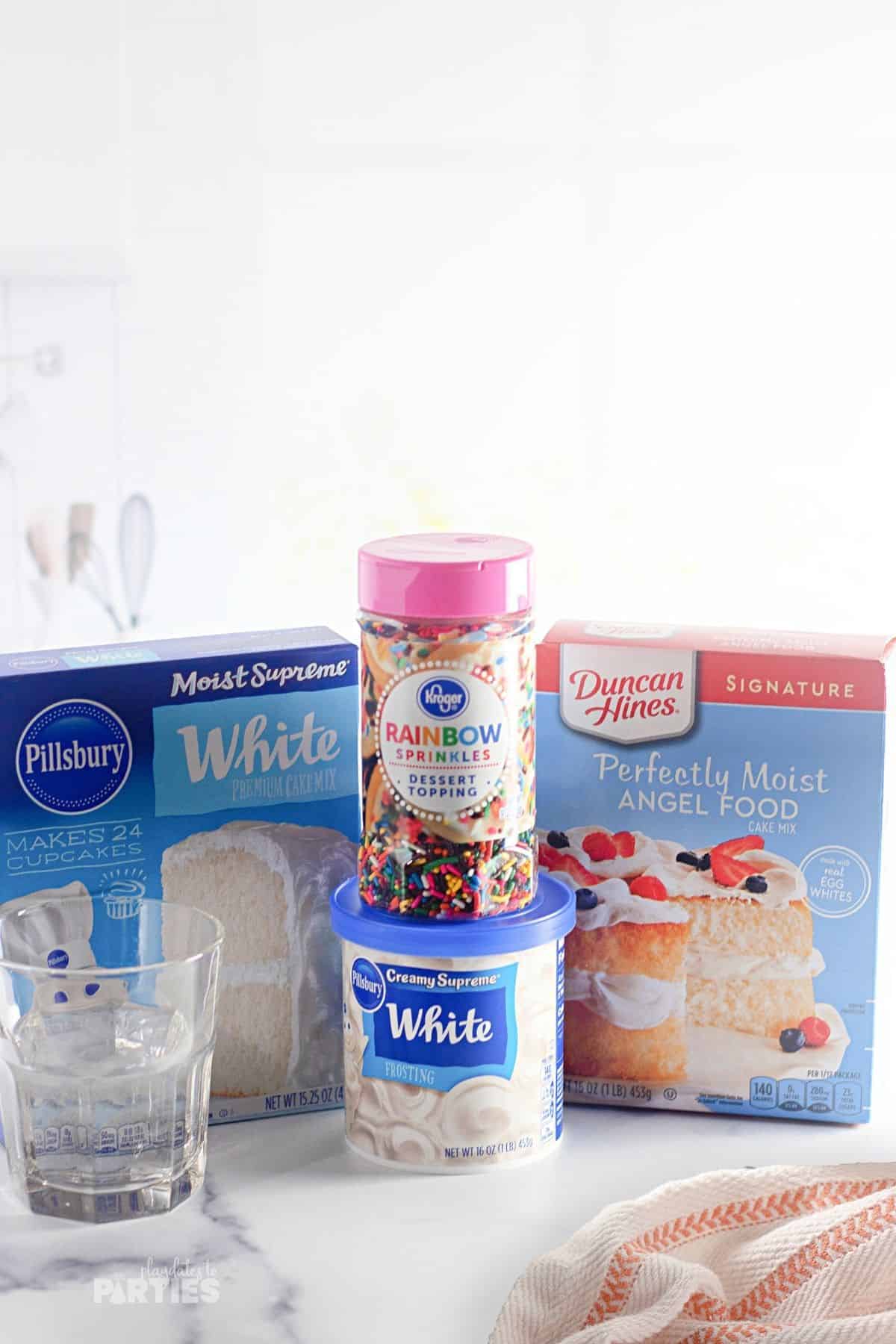 Ingredients include two box cake mixes, sprinkles, water, and frosting.