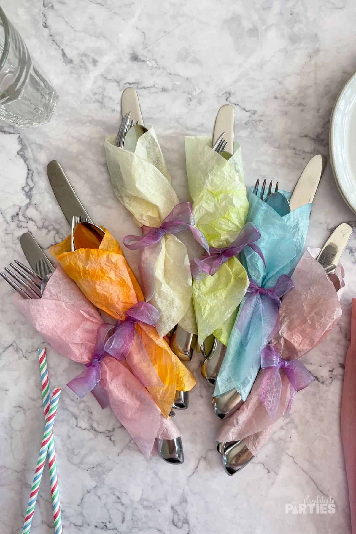 Pastel Easter utensil wraps ready for Easter dinner table decor.