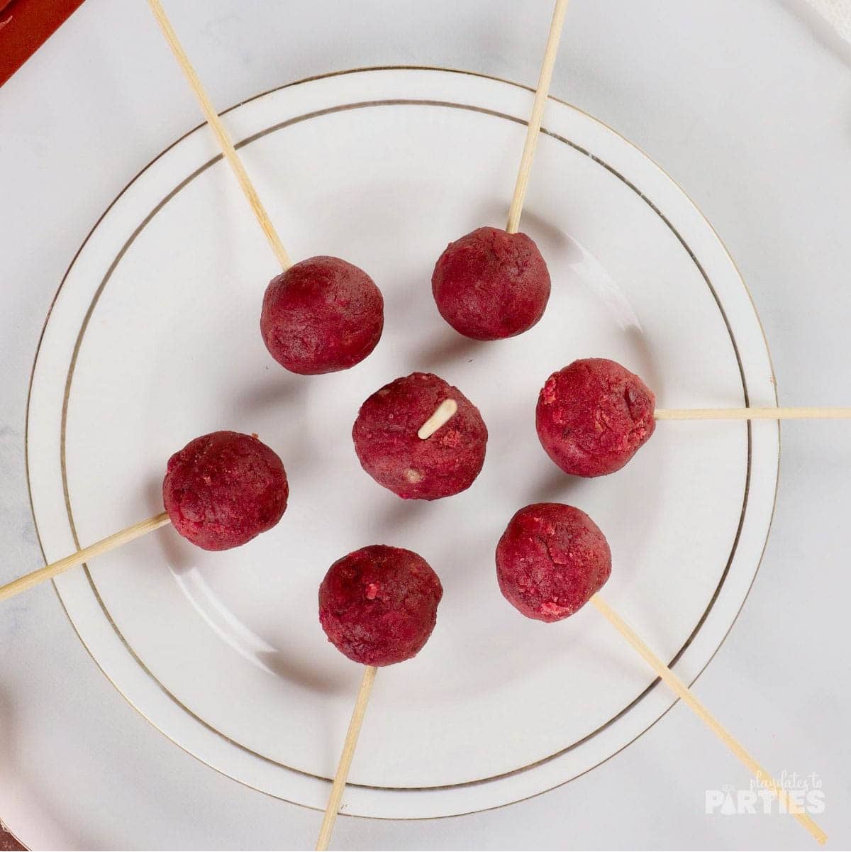 Bamboo skewers inserted into cake balls.