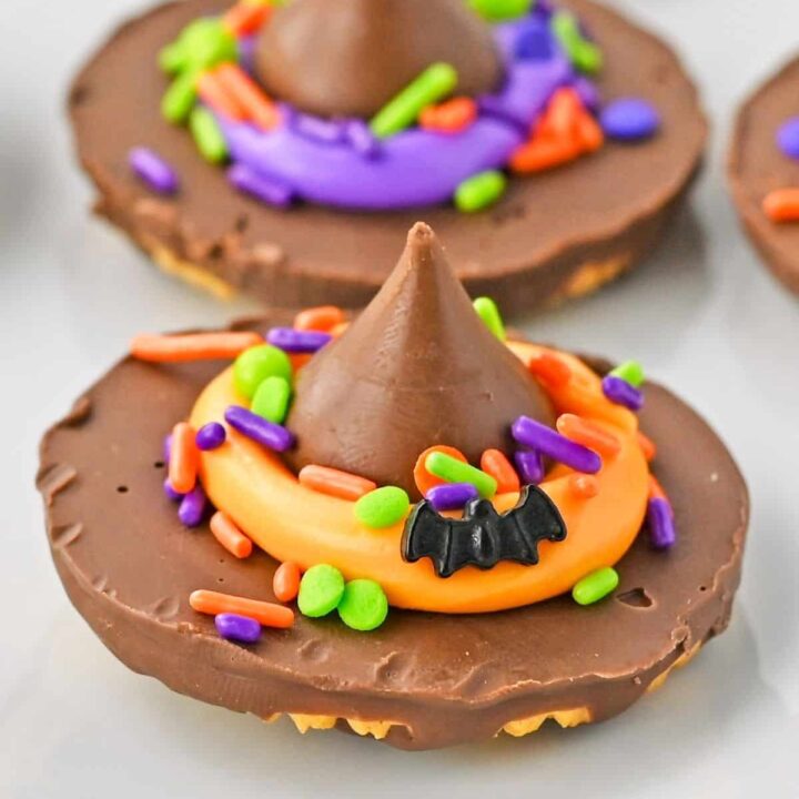 Finished witch hat cookies on a white plate.