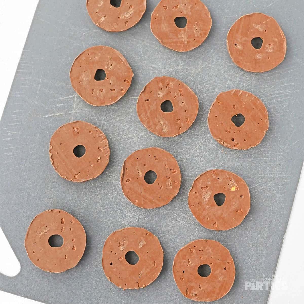 Fudge stripe cookies placed upside down on a silicone baking mat.