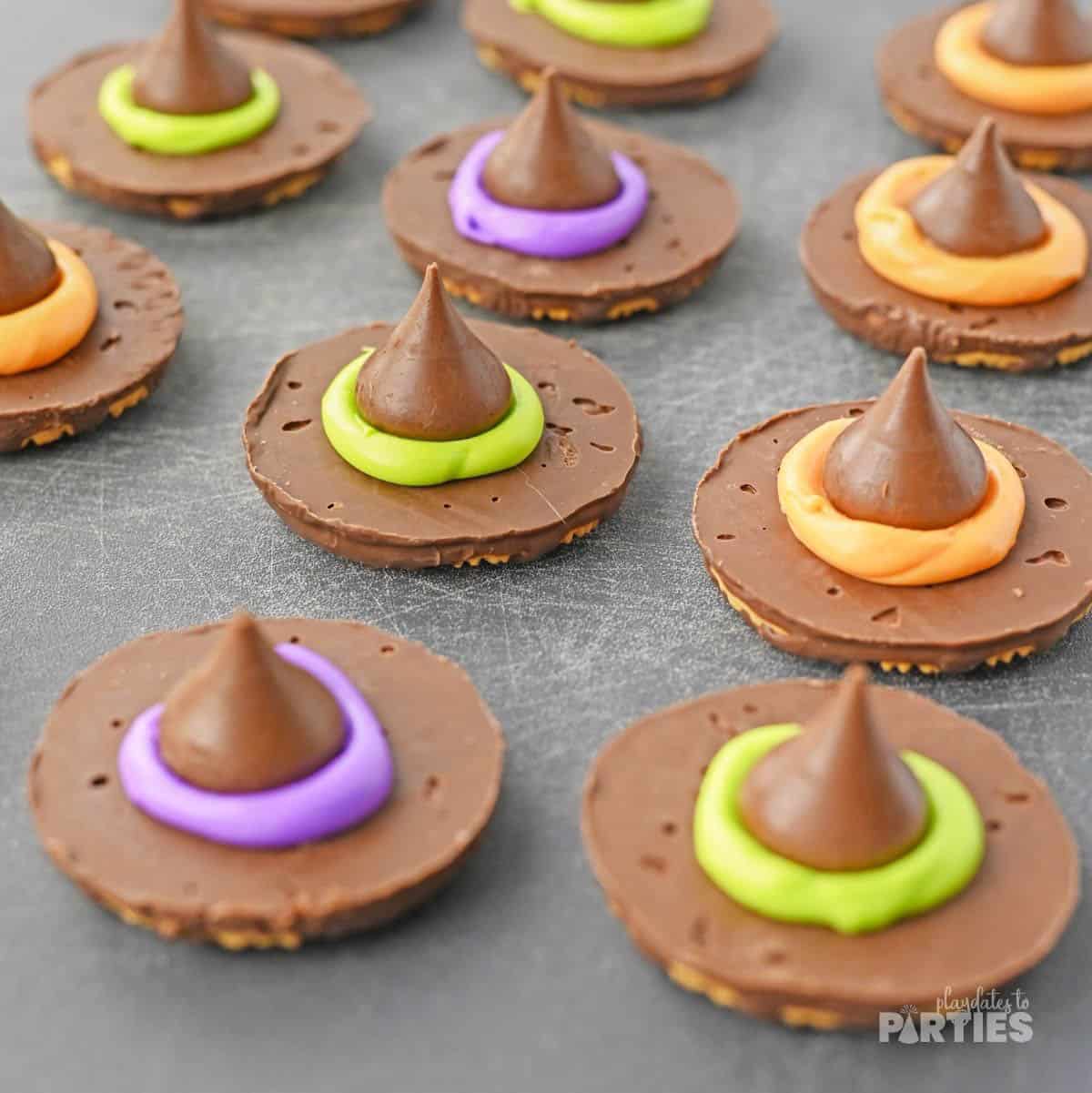 Hershey's kisses are glued to chocolate cookies with colorful ici.