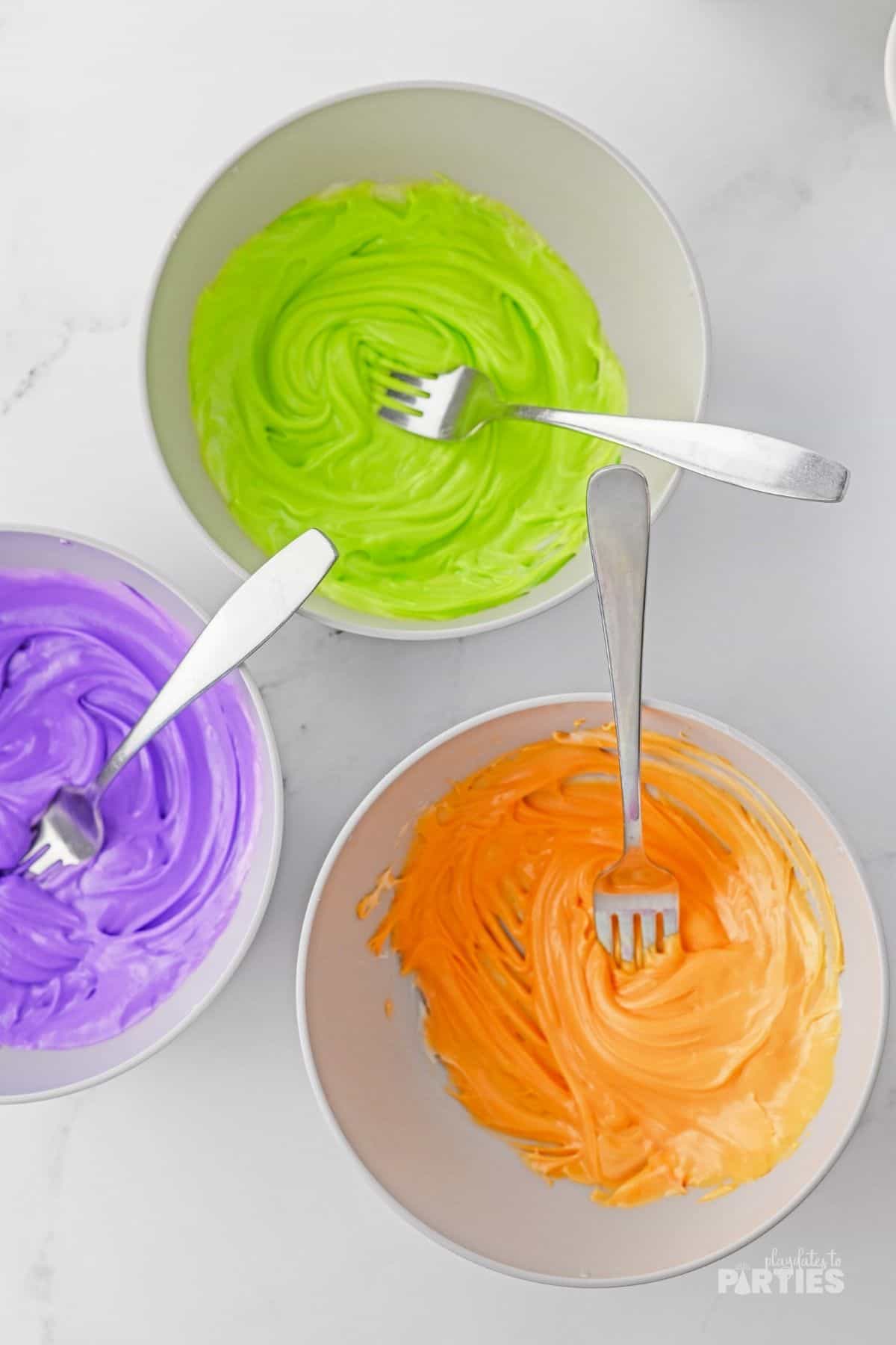 Icing colored orange, green, and purple.