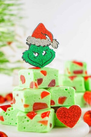 Grinch Nougat Candy stacked on a white surface.