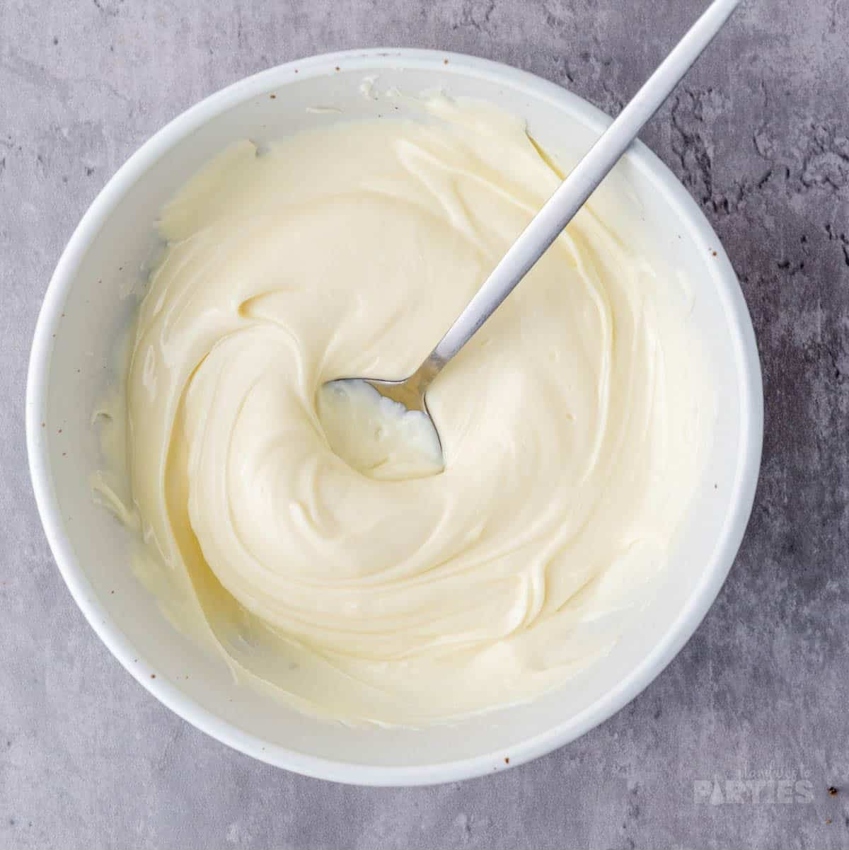 Melted white chocolate in a bowl.